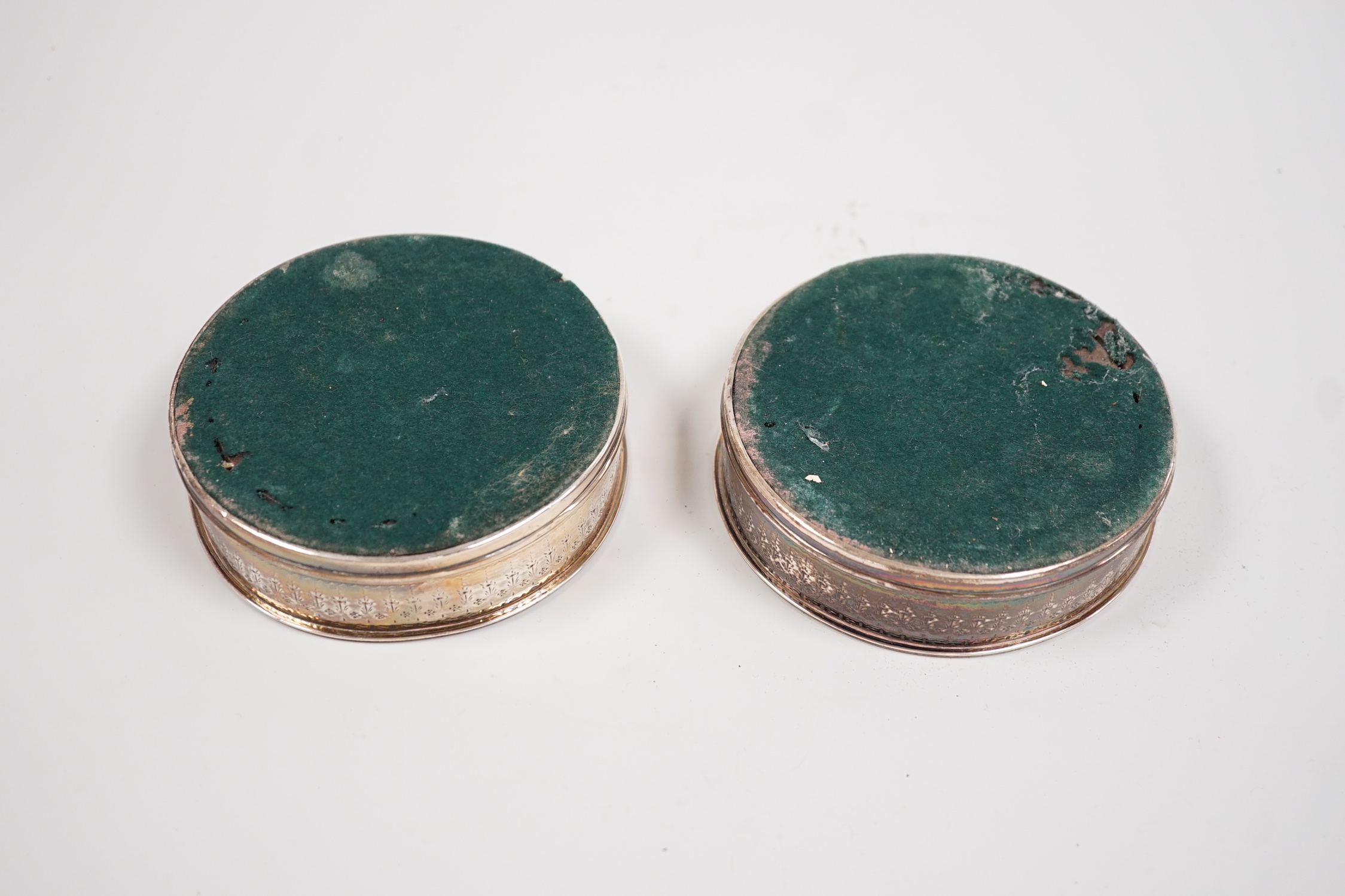 A pair of George III silver mounted wine coasters, makers mark rubbed, London, 1786, diameter 11.4cm.